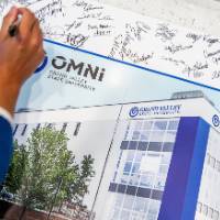 Someone signing photo of new building